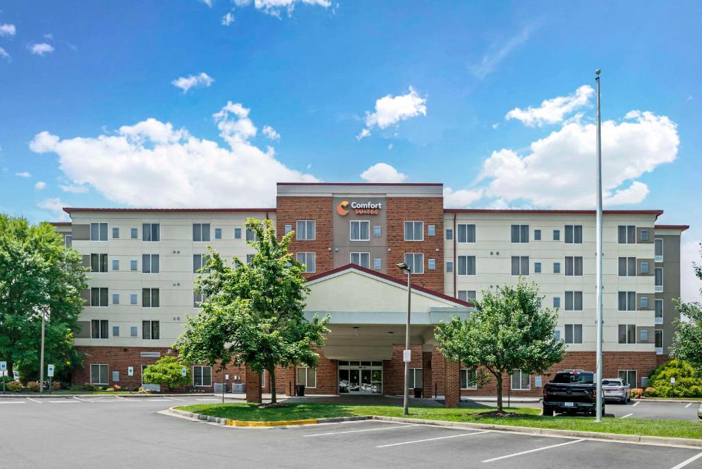 a building with a parking lot in front of it at Comfort Suites at Virginia Center Commons in Richmond