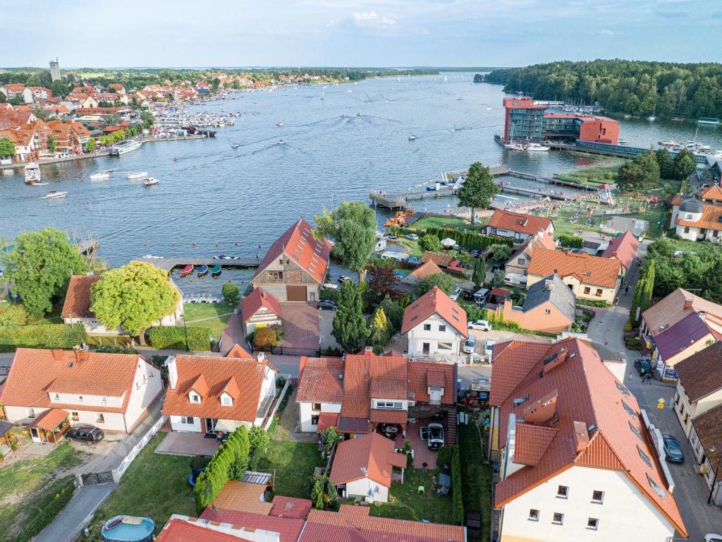 an aerial view of a town next to a river at Agamim Apartments in Mikołajki