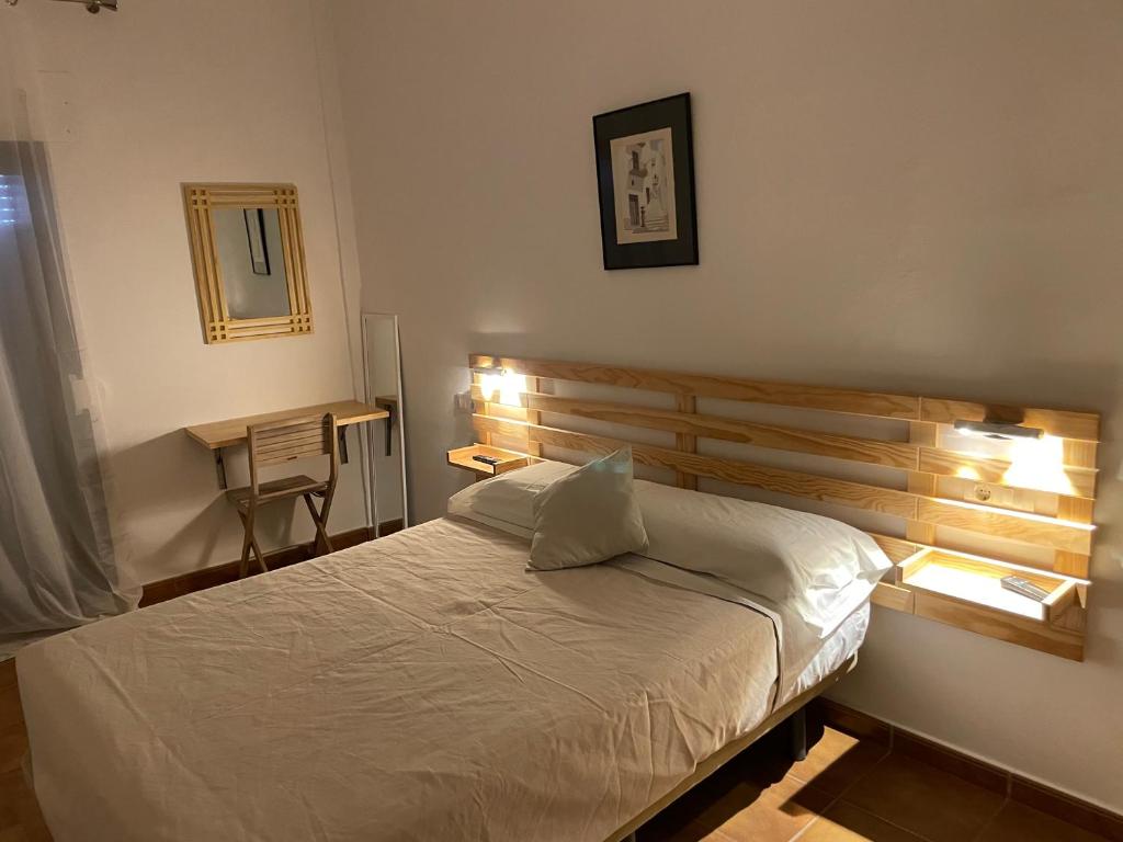 A bed or beds in a room at Hostal Rio