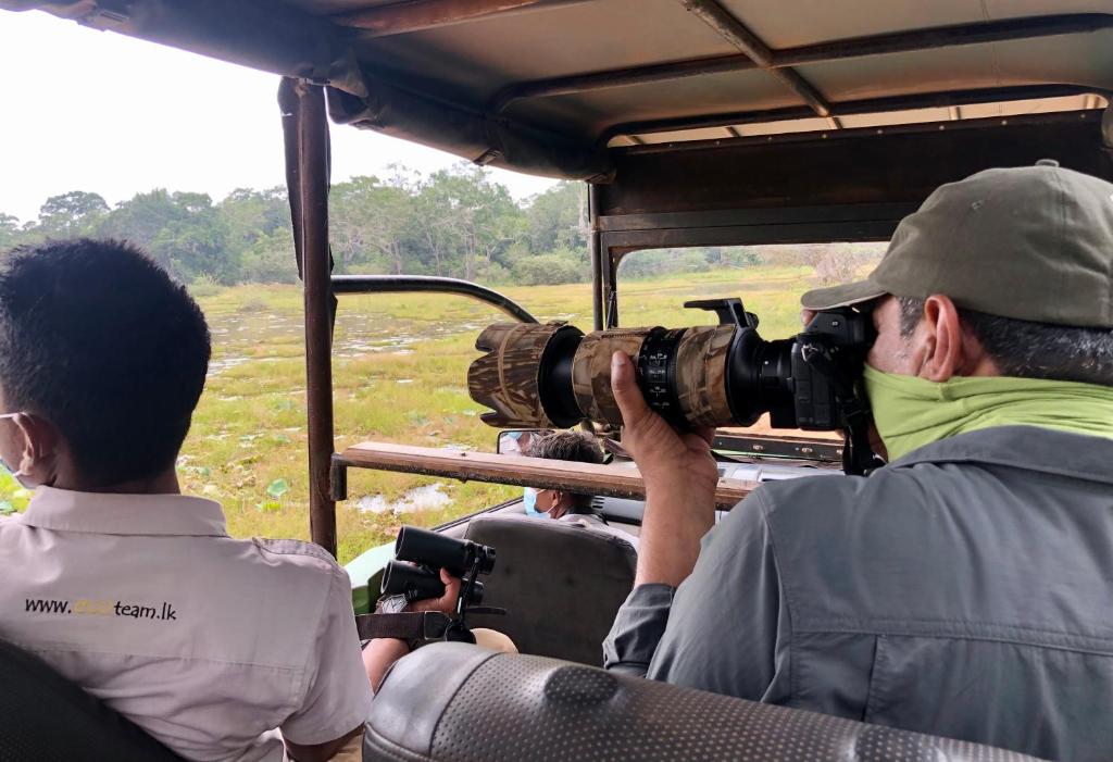 a man taking a picture of a man with a camera at Mahoora Wilpattu - by Eco Team in Wilpattu