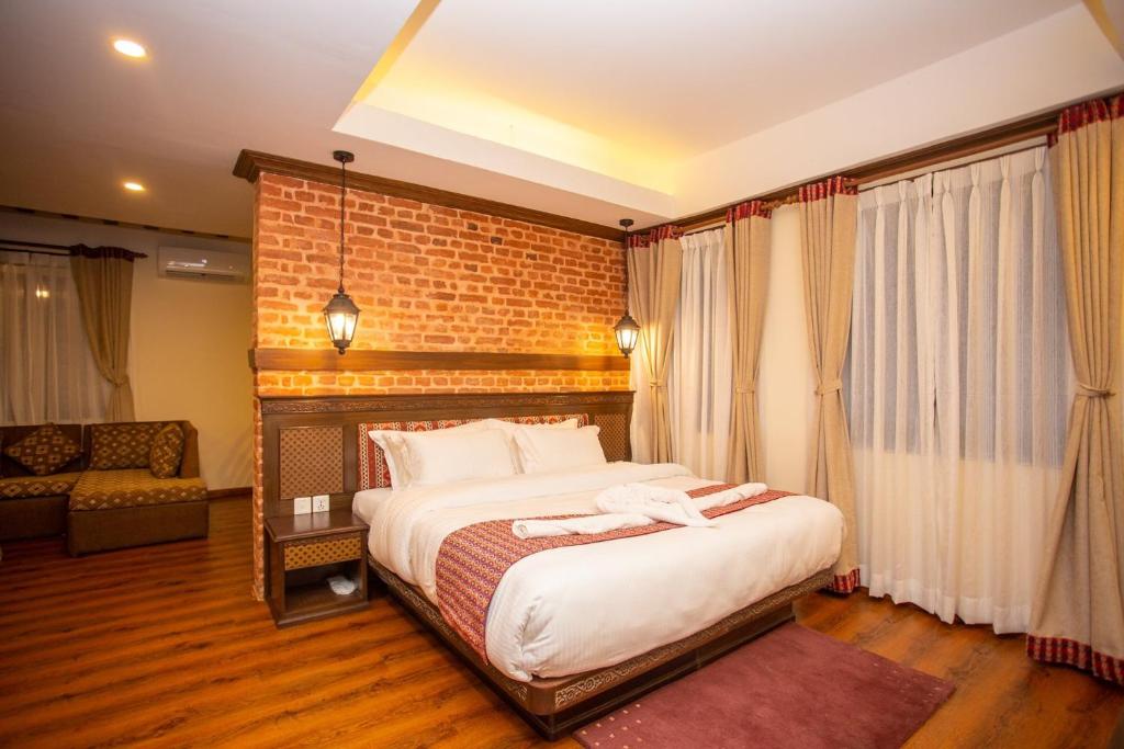 Postel nebo postele na pokoji v ubytování Pashupati Boutique Hotel & Spa