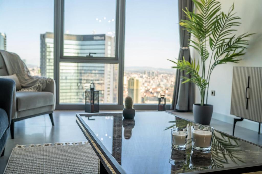 a living room with a glass table and a large window at City View Apt - Panoramic Views Of The City in Istanbul
