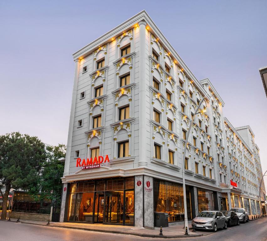 a tall white building with a sign on it at Ramada by Wyndham Istanbul Umraniye in Istanbul