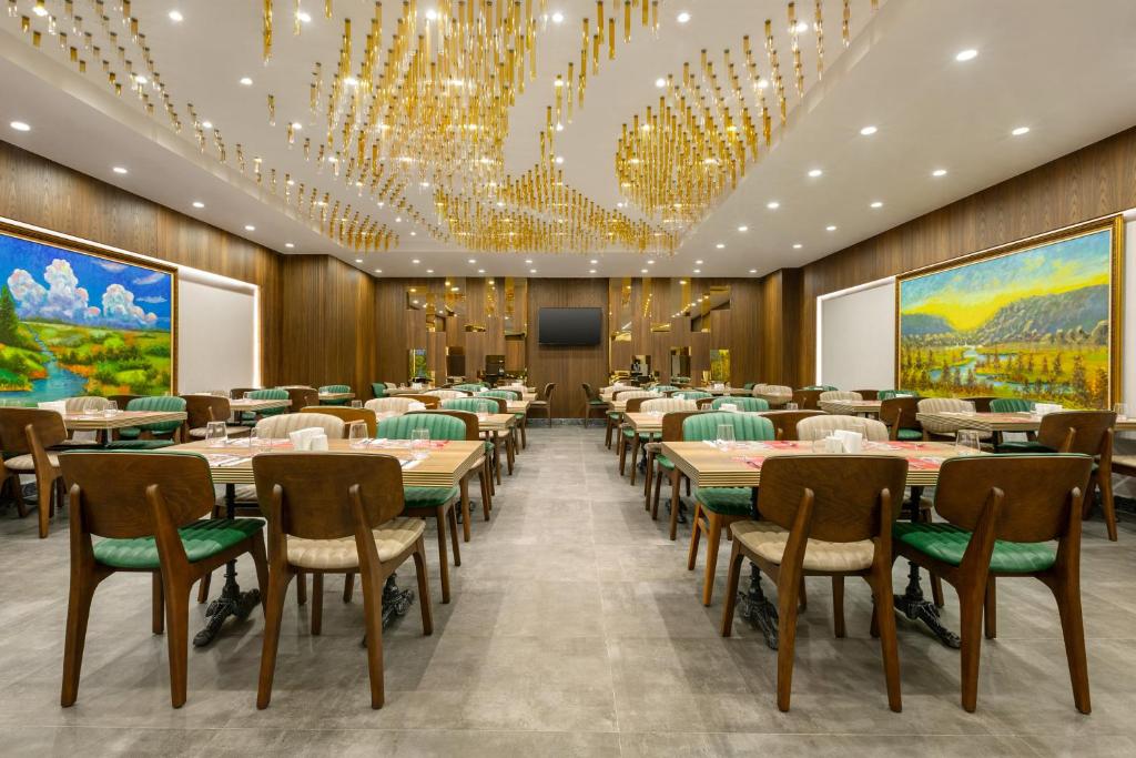 a conference room with tables and chairs and chandeliers at Ramada by Wyndham Istanbul Umraniye in Istanbul