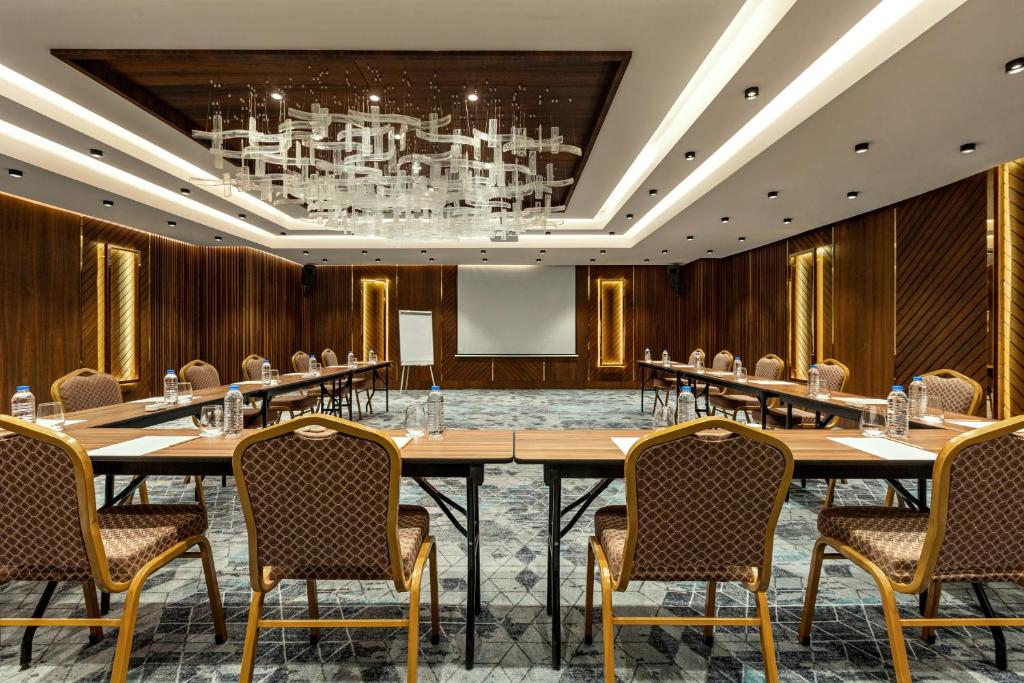 a large conference room with a large table and chairs at Ramada by Wyndham Istanbul Umraniye in Istanbul