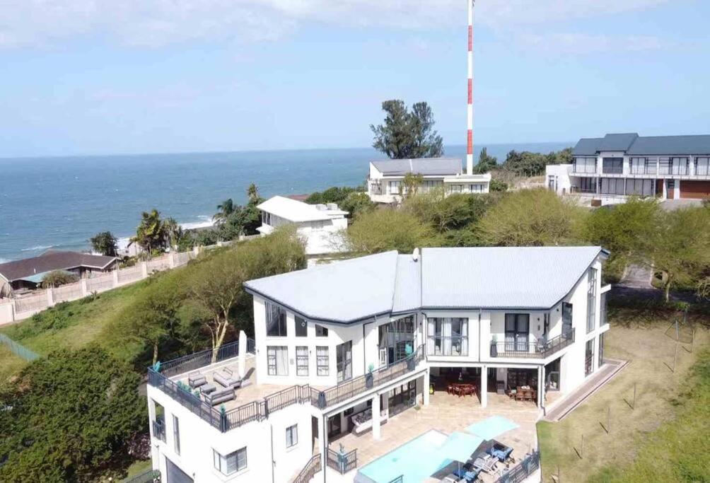 an aerial view of a house with the ocean in the background at The Royal Familia Beach House in Zinkwazi Beach