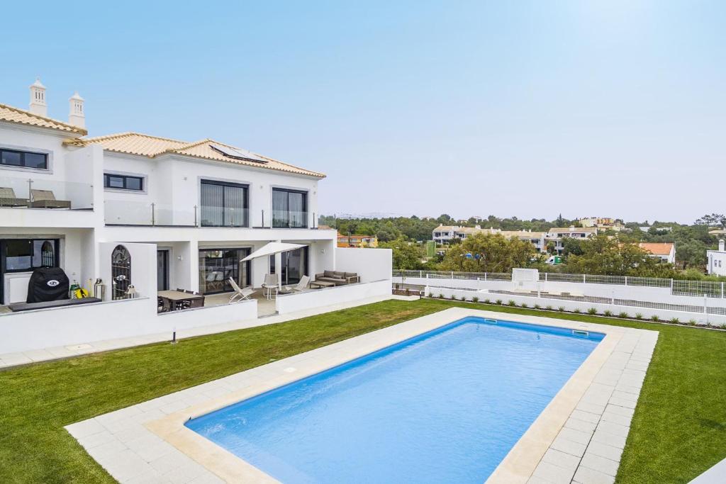 een uitzicht op een huis met een zwembad bij Elegant Luxury Villa by Ideal Homes in Almancil