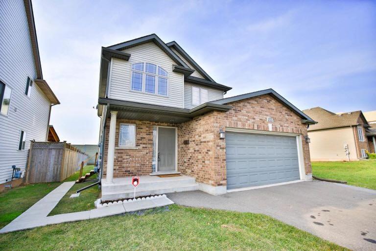 a brick house with a garage in a yard at Beautiful Fallsview Home in Niagara Falls