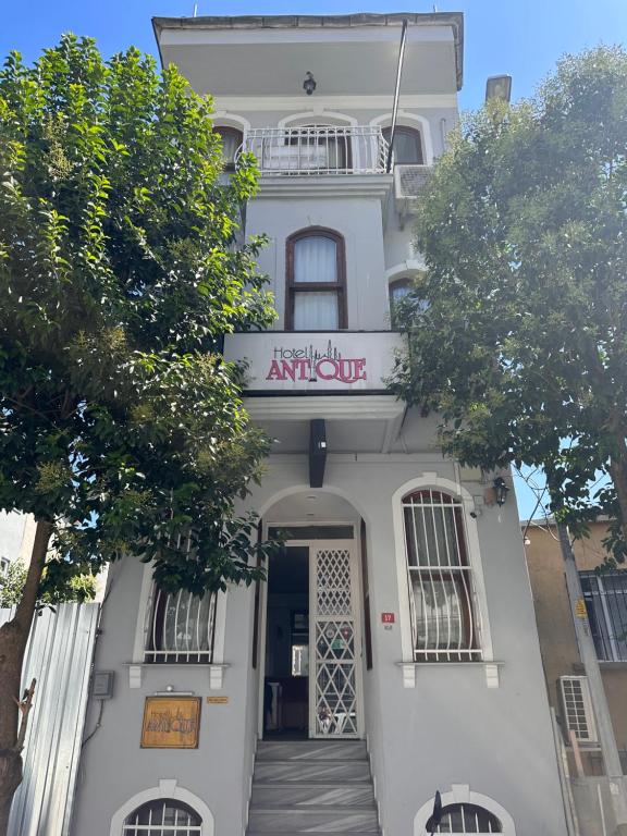 a white building with a sign on the front of it at Hotel Antique in Istanbul