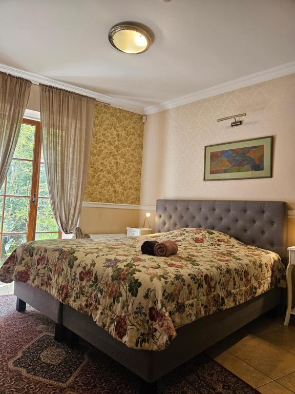 a bedroom with a bed with a stuffed animal laying on it at Barrister's apartments with fireplace in Šiauliai