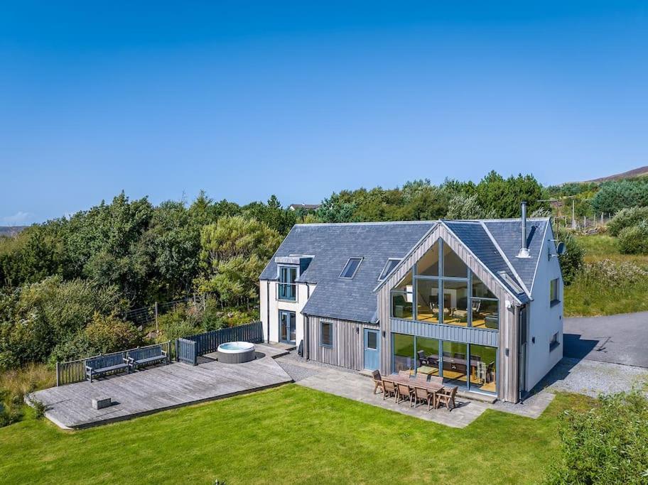 an aerial view of a house with a yard at Locholly Lodge in Achiltibuie