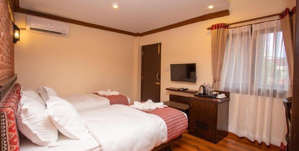 Postel nebo postele na pokoji v ubytování Pashupati Boutique Hotel & Spa