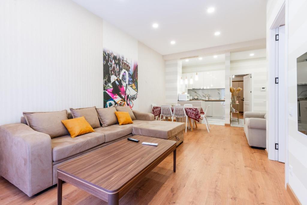 a living room with a couch and a table at Luxury Sweet Home 4 at Freedom Square in Tbilisi City
