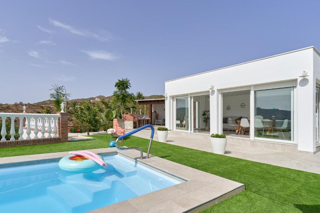 a swimming pool in a yard with a house at Entre montañas in Árchez