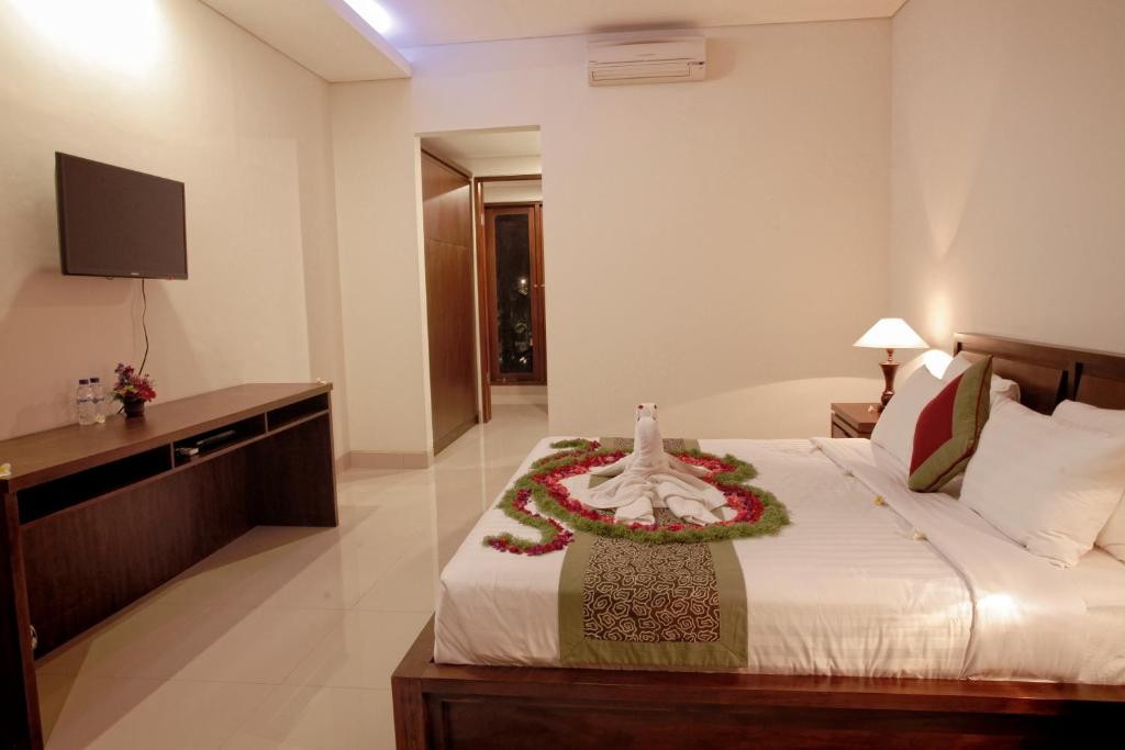 Postel nebo postele na pokoji v ubytování Lili Cottage Ubud