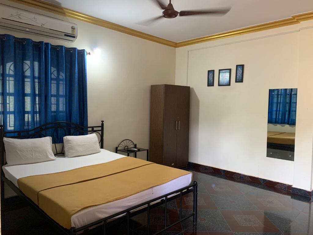 a bedroom with a bed and a ceiling fan at Casa De Calangute Inn in Calangute