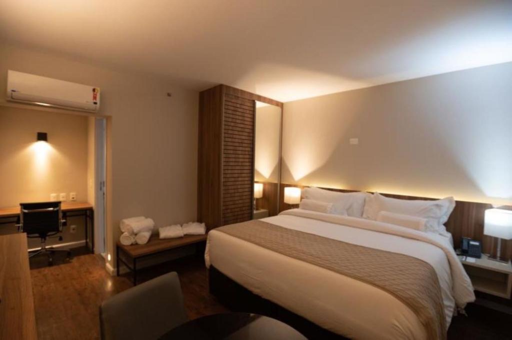 Cama ou camas em um quarto em Intercity BH Expo