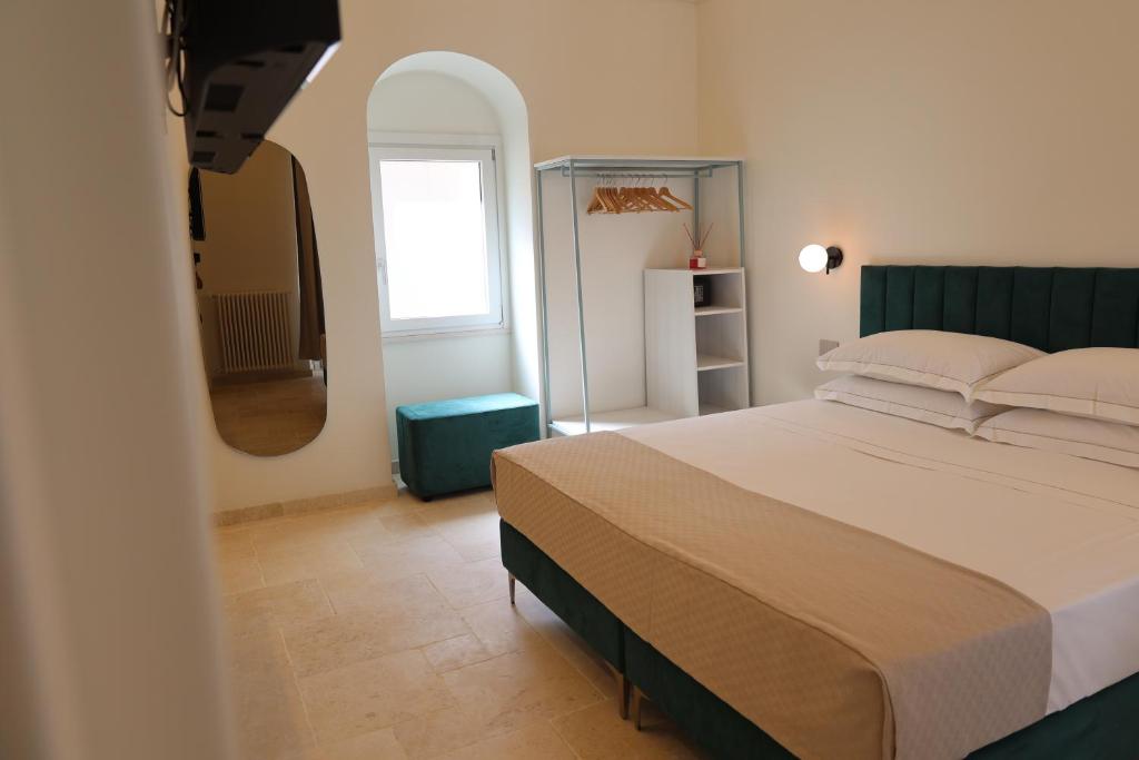 Postel nebo postele na pokoji v ubytování Suites Dimora Garibaldi