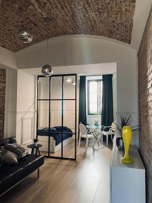 a living room with a couch and a bedroom at Lux apartment near Wawel in Krakow