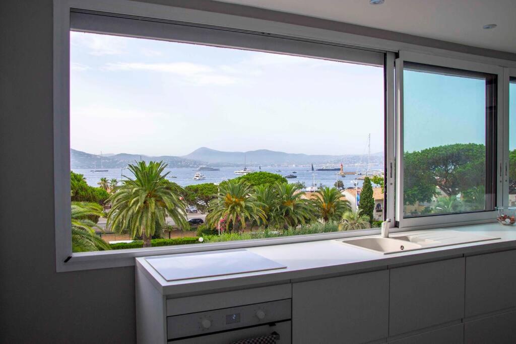 a kitchen window with a view of the water at Sérénité Marines ‣Incredible Sea view in Saint-Tropez