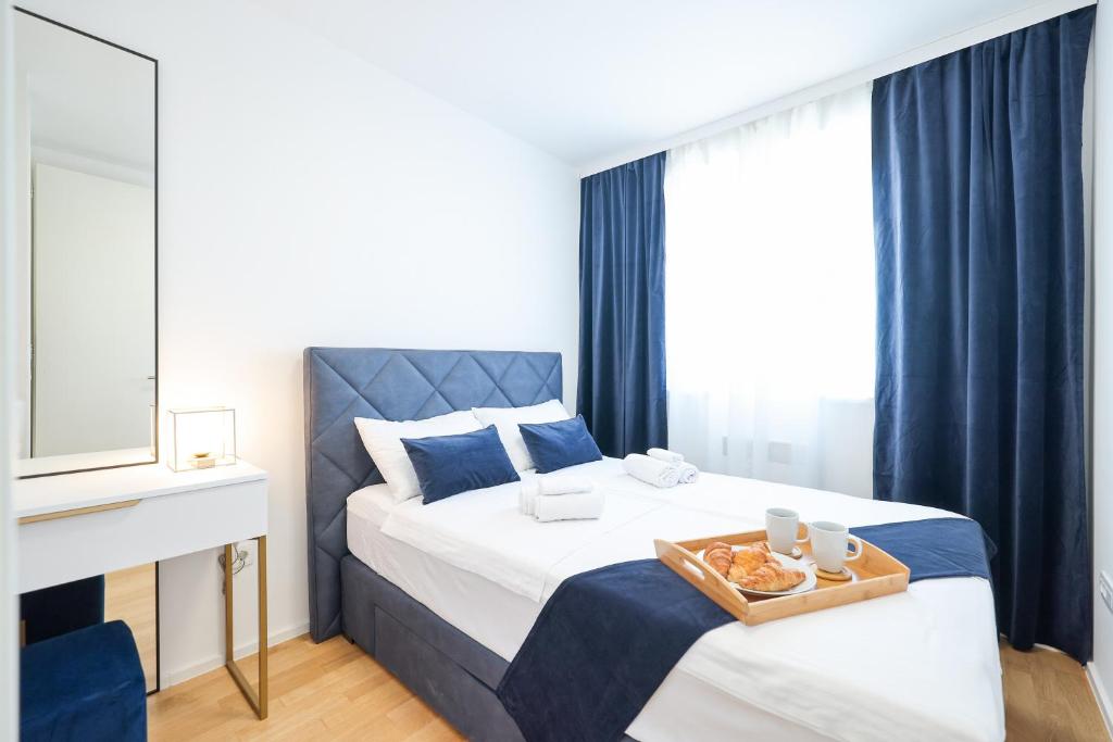 a bedroom with a bed with a tray of food on it at Alpha Level Apartment in Zadar