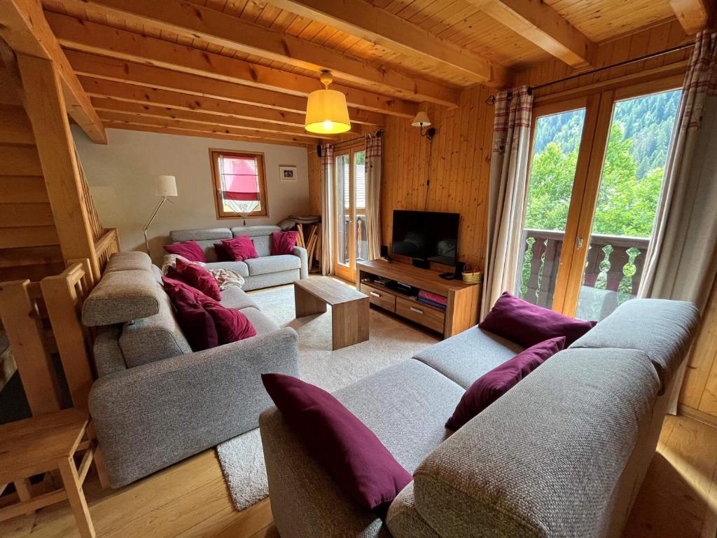 a living room with couches and a tv at Chalet Châtel, 5 pièces, 8 personnes - FR-1-198-220 in Châtel