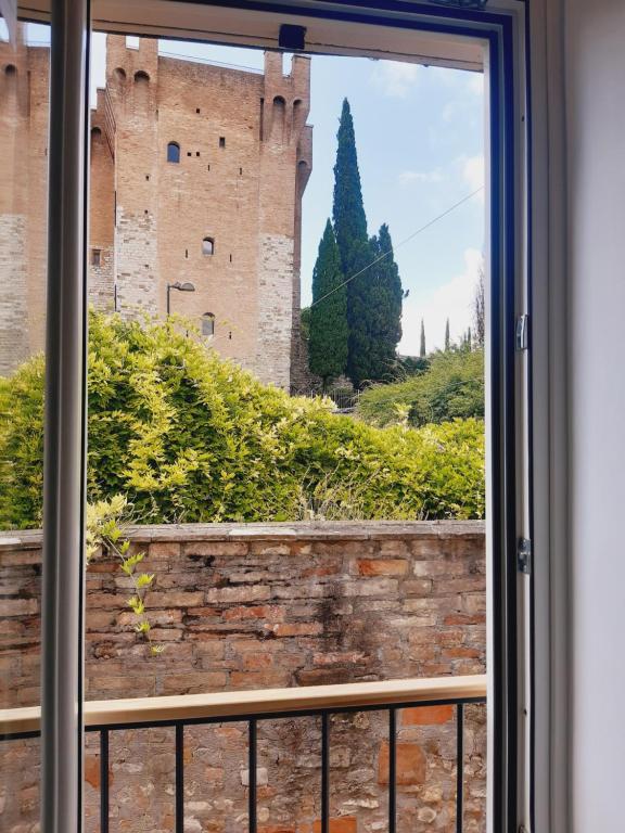 a window with a view of a castle at Casina a Porta Sant'Angelo in Perugia