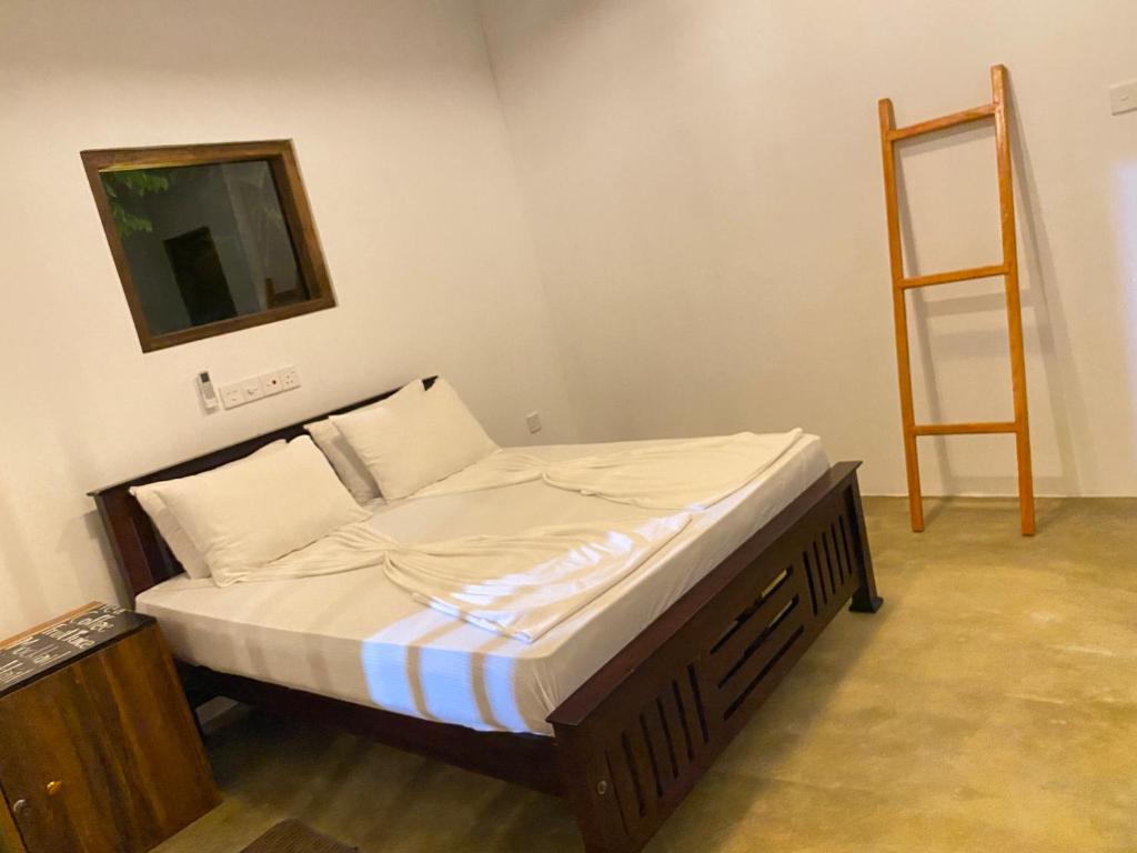 Postel nebo postele na pokoji v ubytování Muthu Hiriketiya