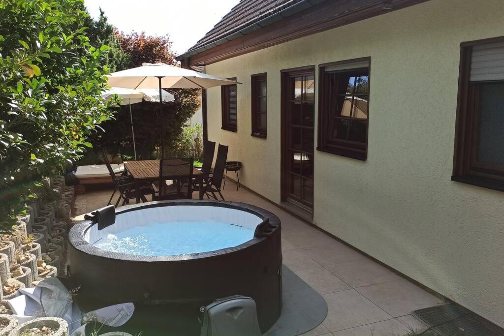 a hot tub on a patio next to a house at Wohnung mit Spielplatz, Kaninchen und Whirlpool in Grafenhausen