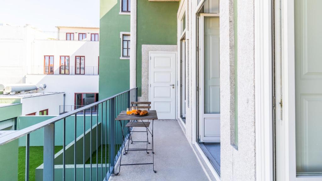 a balcony with a table and chairs on it at Duque Flat - AC & Balcony by LovelyStay in Porto