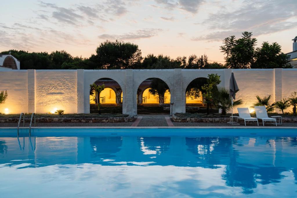 a view of a swimming pool at dusk at Masseria Gorgognolo in Ostuni