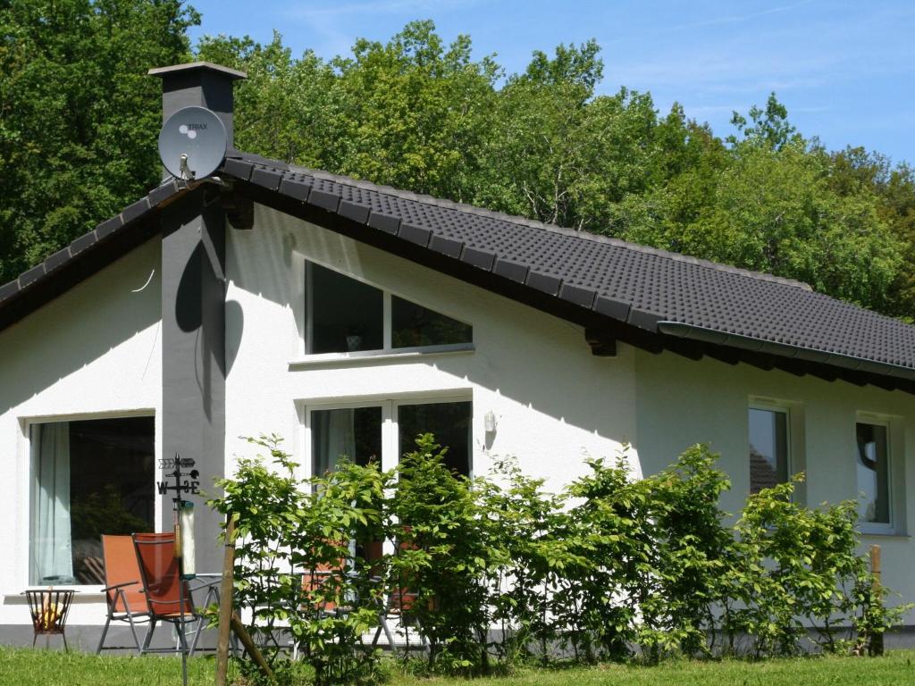 a white house with a solar roof at Detached bungalow with dishwasher in a green area in Kopp