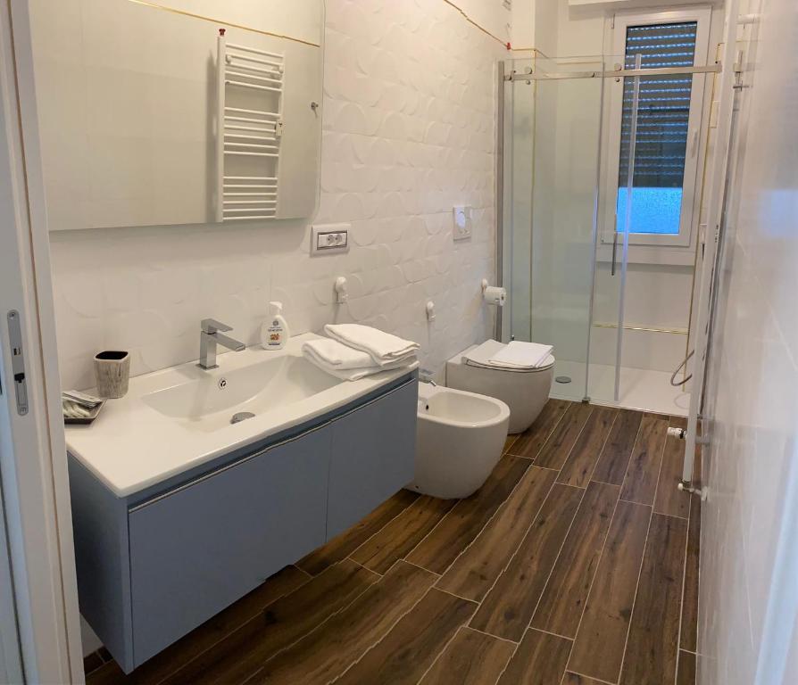 a bathroom with a sink and a toilet and a shower at SestoHome26 in Sesto San Giovanni