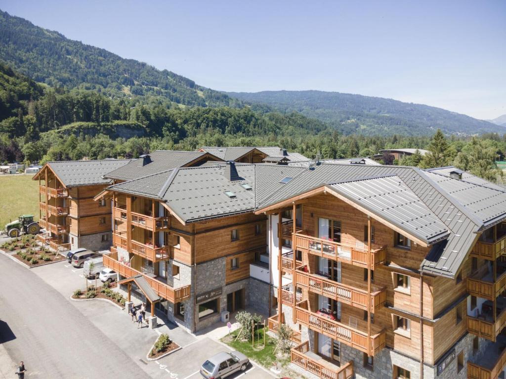 an aerial view of a apartment building with mountains in the background at Beautiful residence with Spa in cozy Samo ns in Samoëns