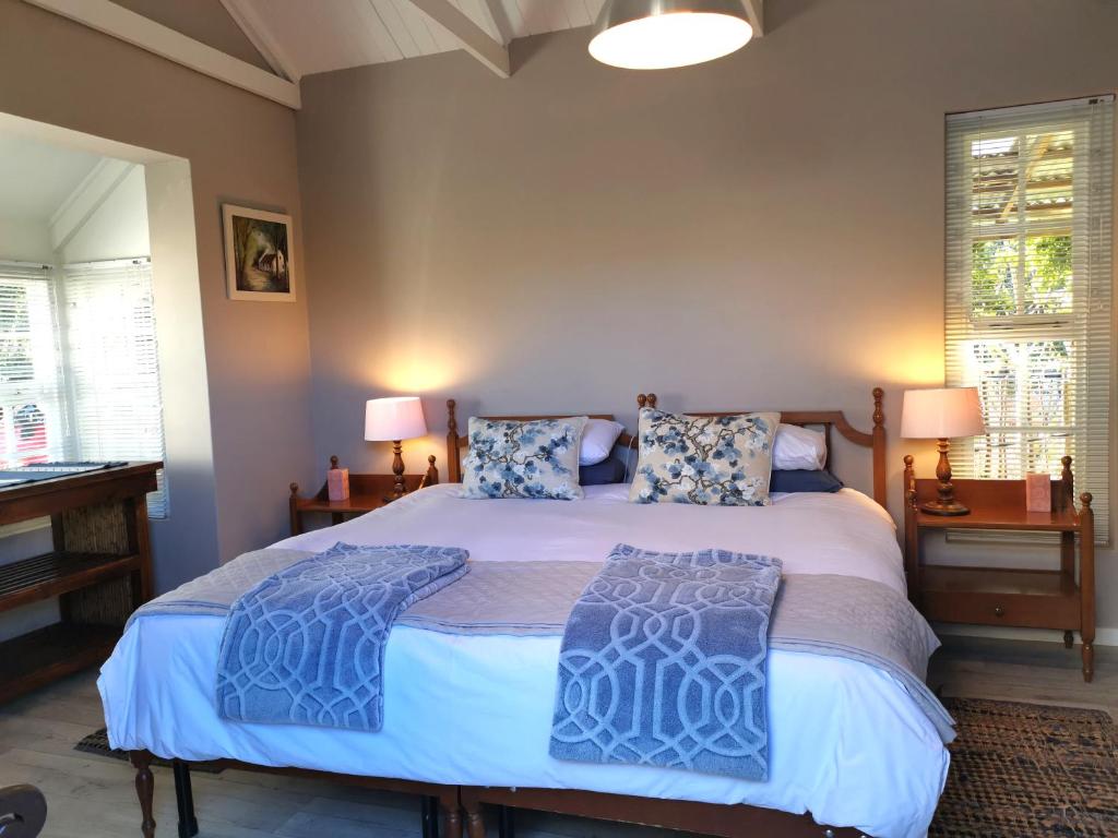 a bedroom with a large bed with two pillows on it at 30 Oak Street in Greyton