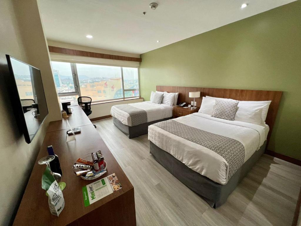Postel nebo postele na pokoji v ubytování Wyndham Garden Guayaquil