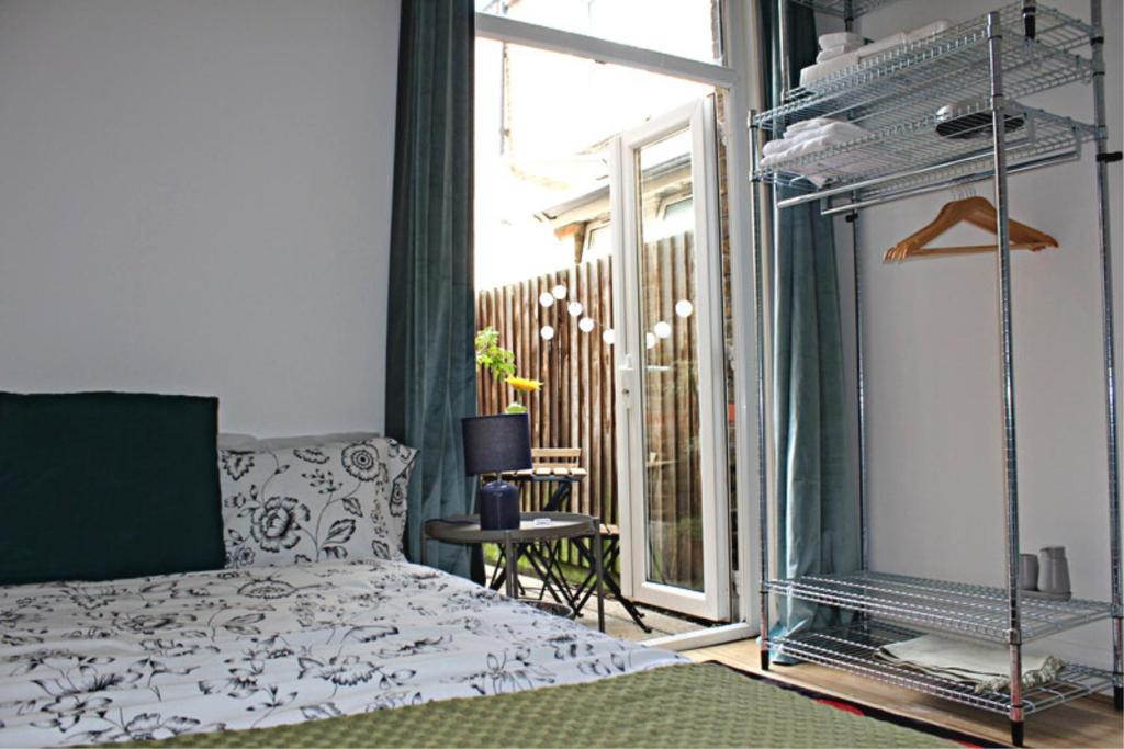 a bedroom with a bed and a large window at Urban Retreat in London