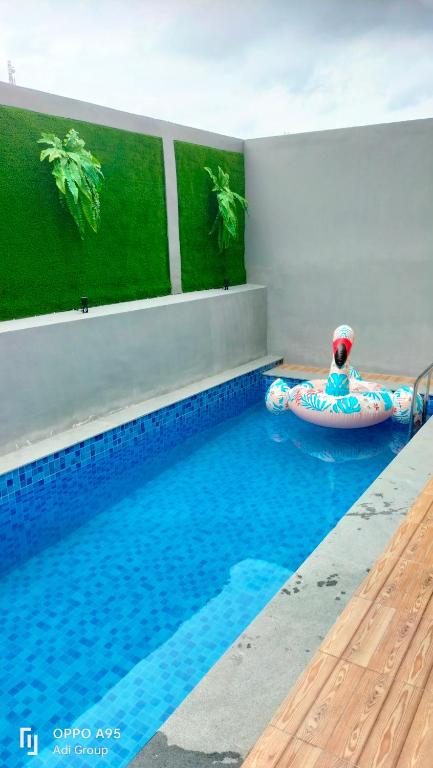 a swimming pool with a inflatablelatablepool in the middle of a house at Villa Adigroup bayar Offline in Tlekung