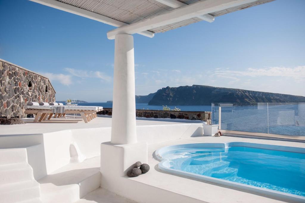 a hot tub on the roof of a house at Ode Villa in Oia