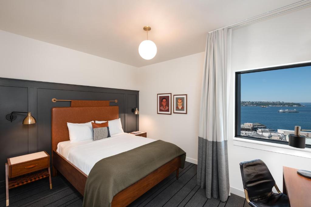 a hotel room with a bed and a large window at The State Hotel in Seattle