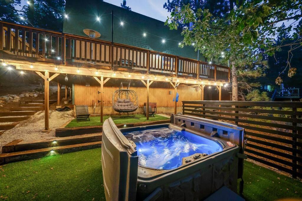 a hot tub in the backyard of a house at Pine Den Cabin: Arcade+Fire Pit+BBQ in Sugarloaf