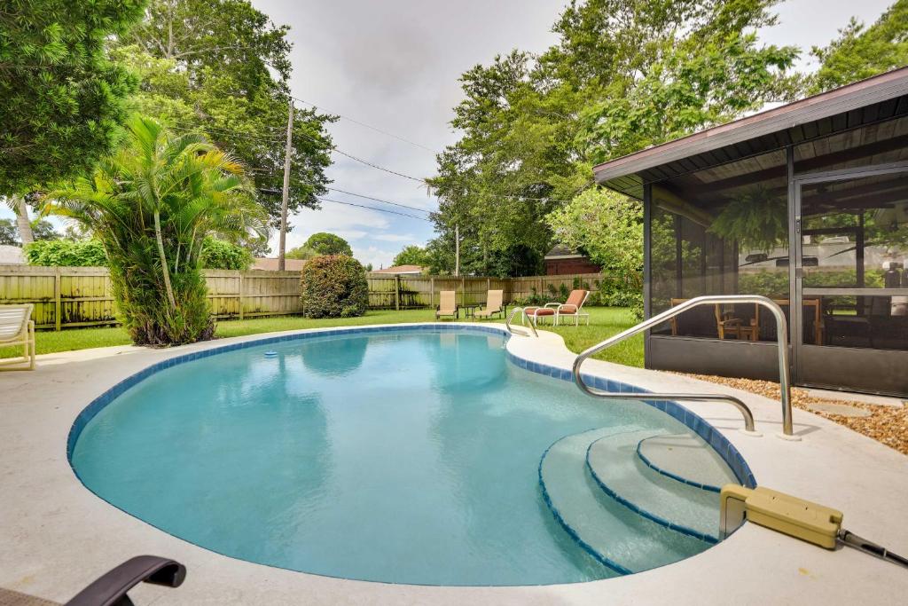 a swimming pool in the backyard of a house at Uncle Louies Gulf Coast Retreat with Outdoor Oasis! in Bradenton