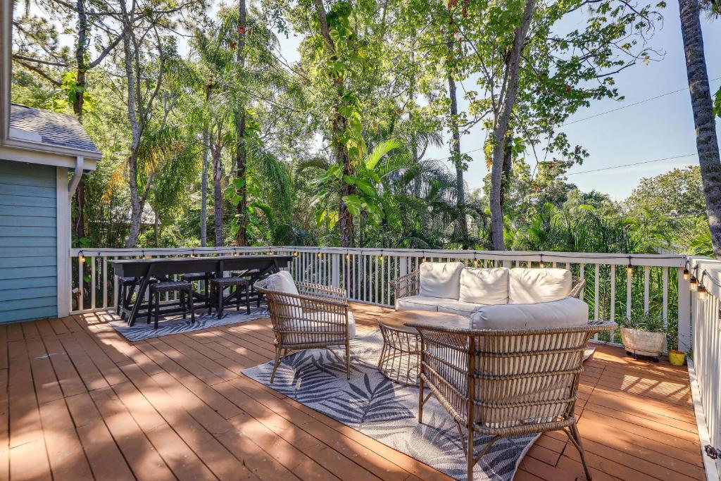 a wooden deck with a table and chairs on it at Private Saltwater Pool Stunning Seminole Stay! in Redington Shores