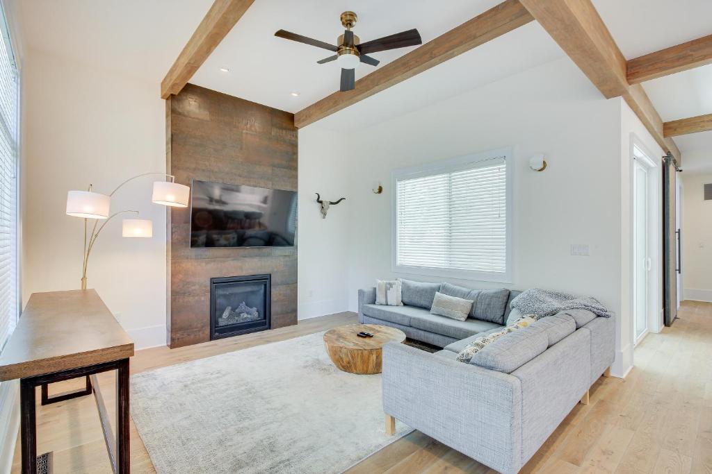 a living room with a couch and a fireplace at Modern Lawrence Home with Patio Less Than Half-Mi to U of K! in Lawrence