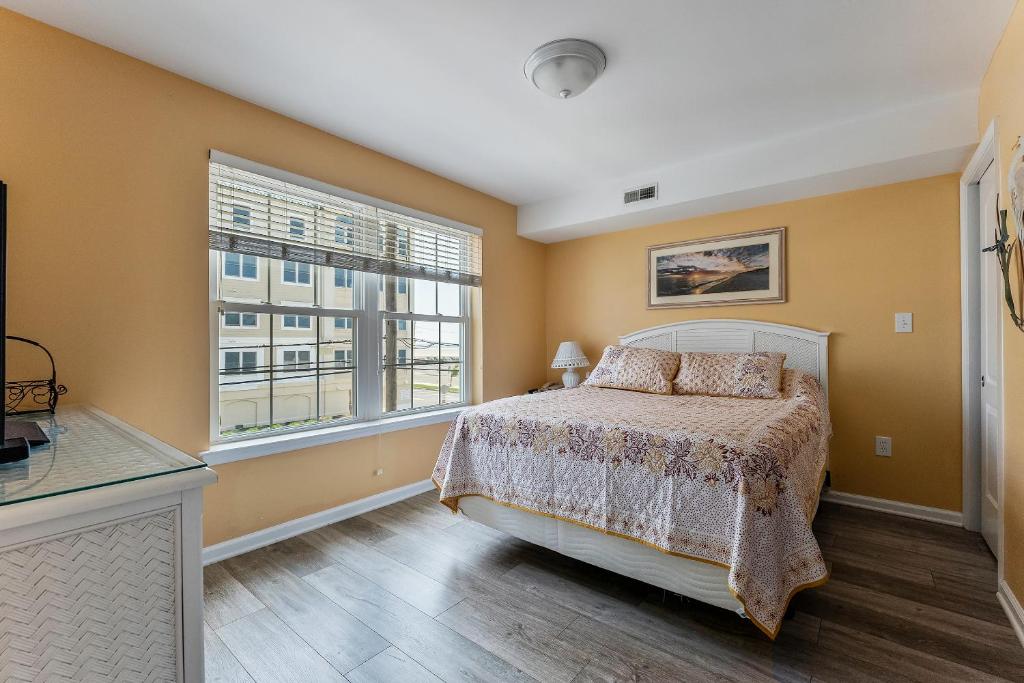 a bedroom with a bed and a window at Nw Resort Condo W Stunning Ocean Views in North Wildwood