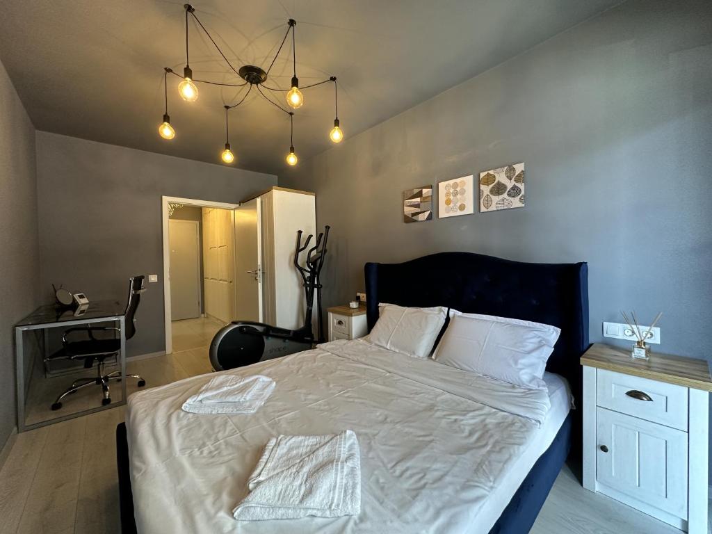 a bedroom with a large bed with white sheets at elisio - Bricks Apartment in Braşov