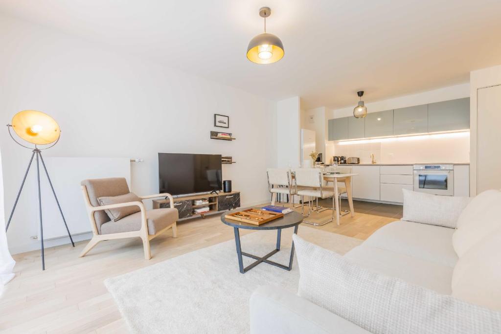un salon avec un canapé et une table dans l'établissement Modern apartment - 2BR-5P - Puces de Saint-Ouen, à Saint-Ouen