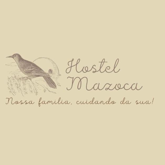 a bird sitting on top of a sign that reads hostel mexico at Hostel Mazoca in Peruíbe