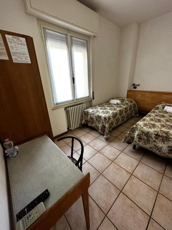 A bed or beds in a room at BE ME Hotel Helvetia
