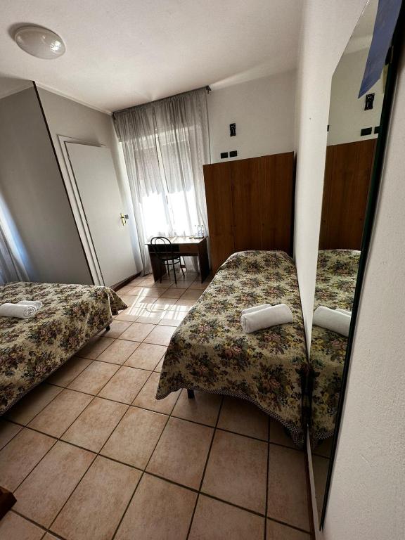 A bed or beds in a room at BE ME Hotel Helvetia